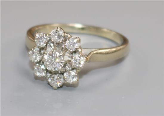 A white metal and nine stone diamond cluster dress ring, size X.